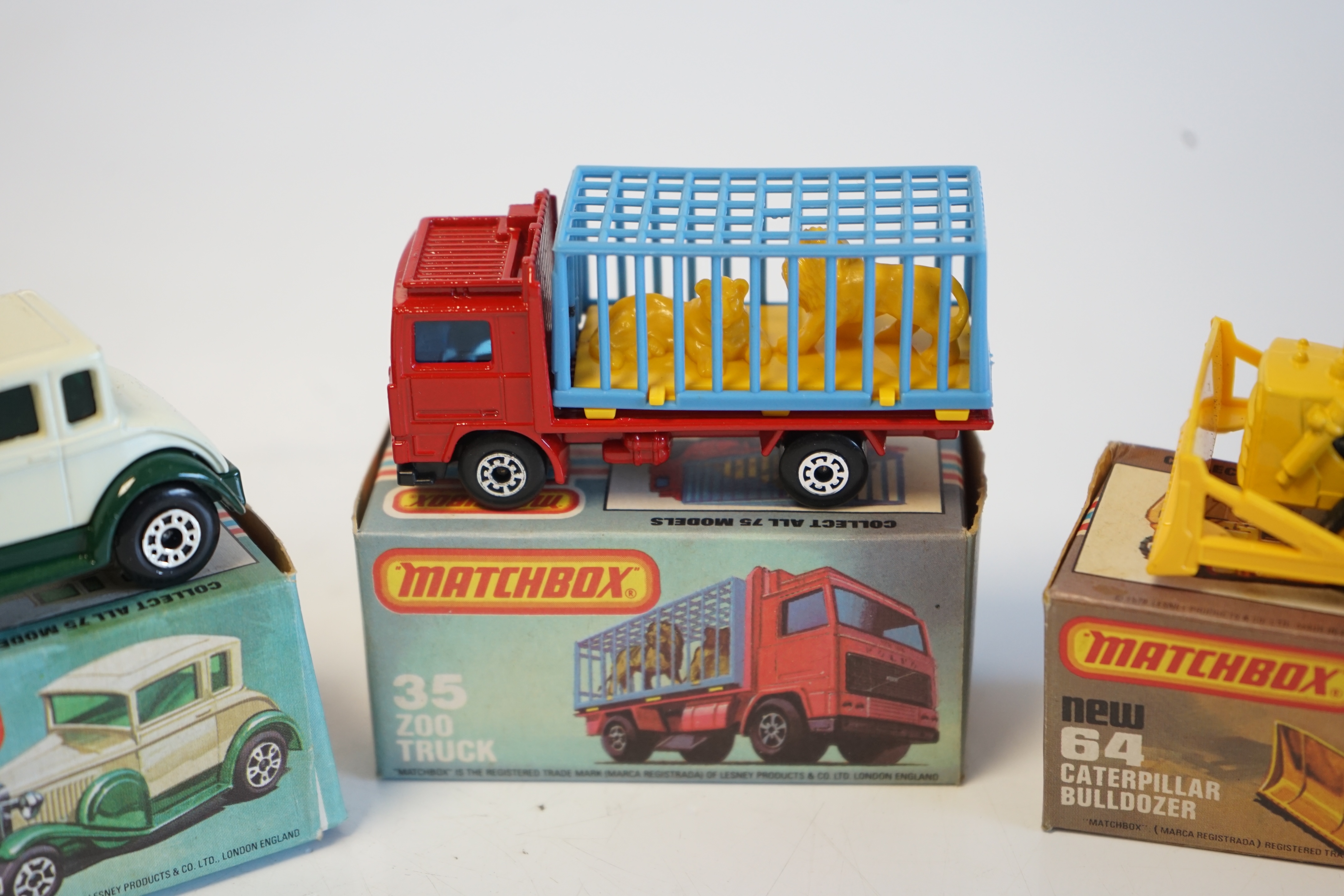 Sixteen boxed Matchbox Series 1-75 diecast vehicles including; 1; Dodge Challenger, 14; Petrol Tanker, 28; Formula Racing Car and another, 34; Chevy Pro Stocker, 35; Zoo Truck and another, 52; Police Launch, 61; Wreck Tr